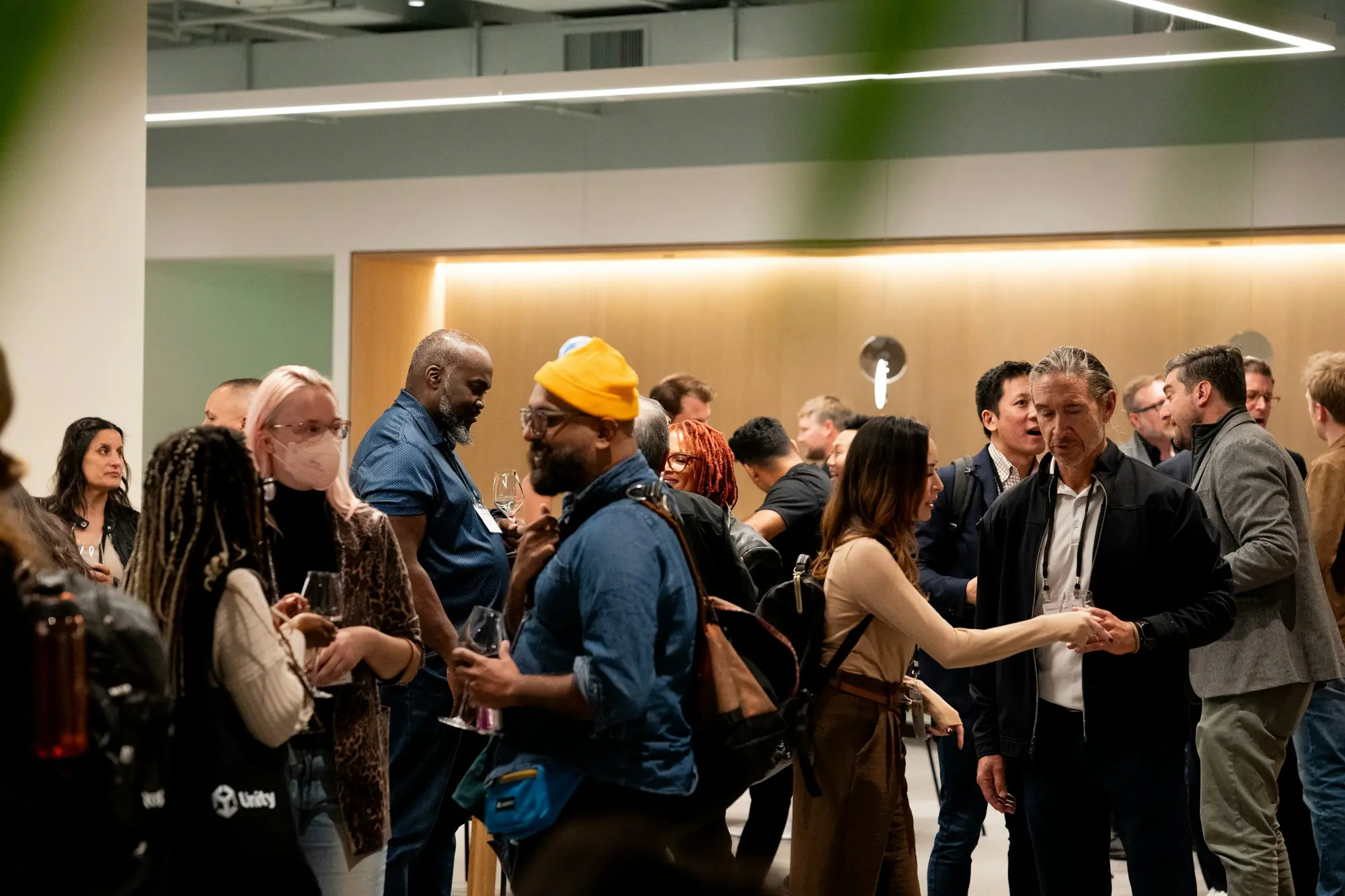 Colleagues mingling at a warmly lit corporate event