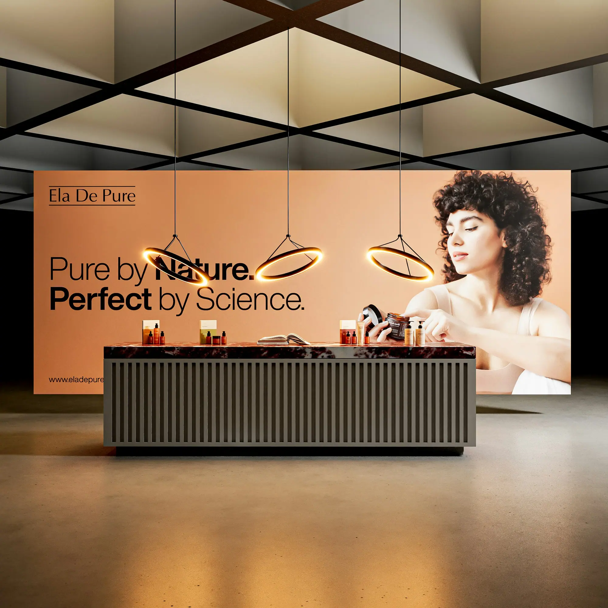 A softly lit sponsor stand with a branded backdrop and product counter