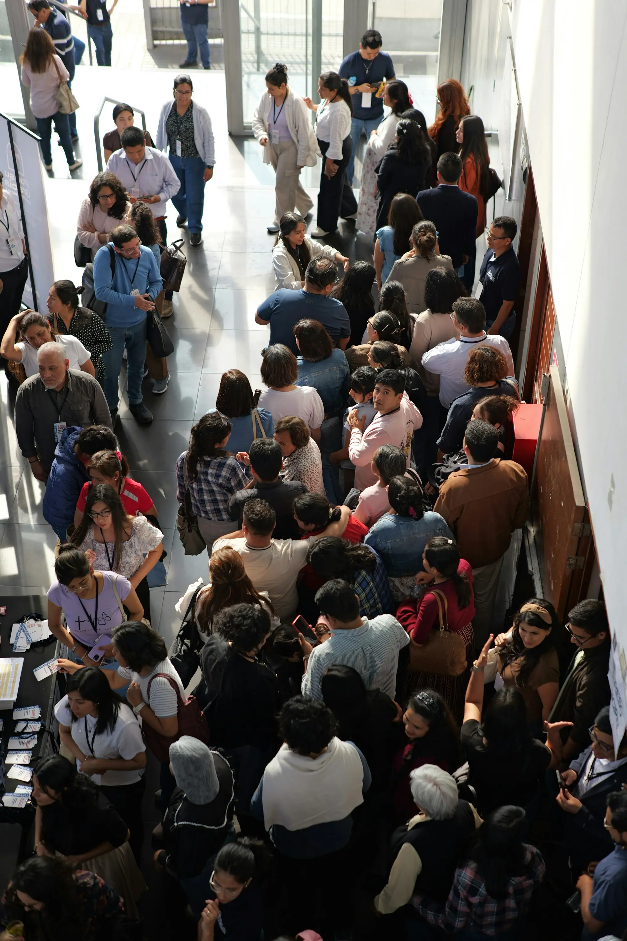 Guests queueing at a conference registration desk